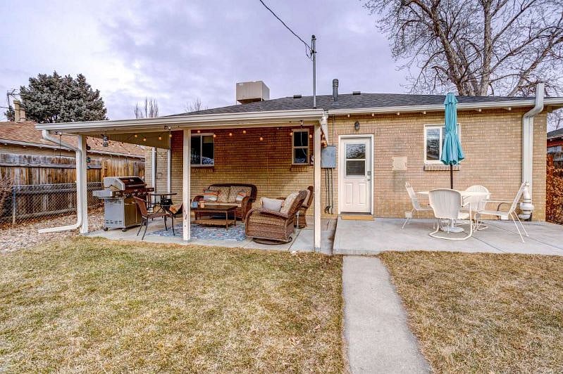 Fenced, private back yard with patio furniture, gas grill