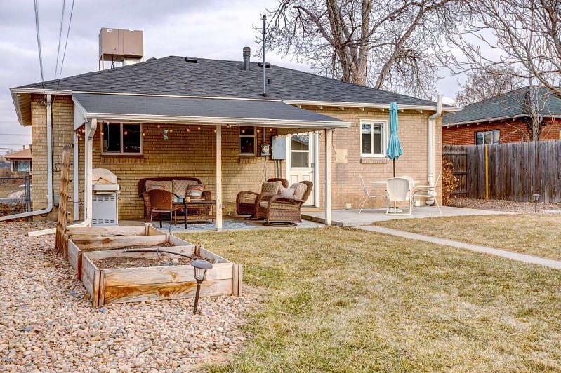 Fenced, private back yard with patio furniture, gas grill
