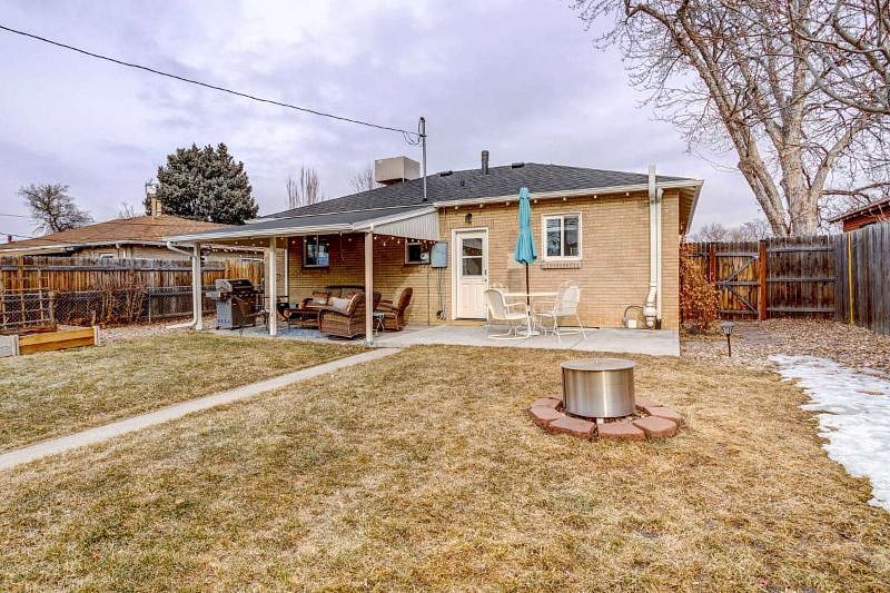 Fenced, private back yard with patio furniture, gas grill, fire pit
