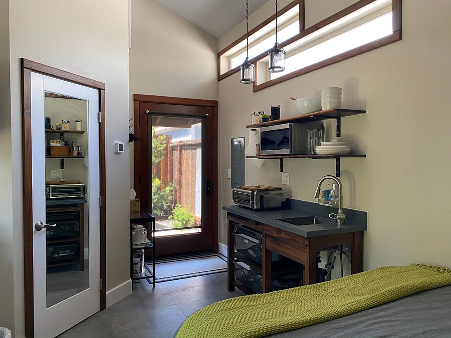 Kitchen area showing backdoor out to private deck. Also shows bathroom door.