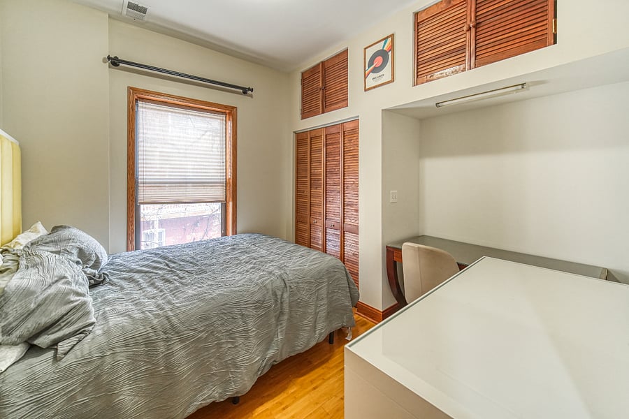 Main floor bedroom with queen bed and mini fridge