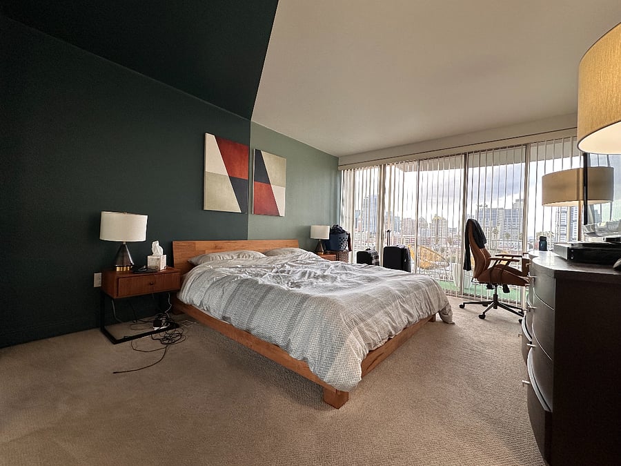 Very Quiet Primary Bedroom with an ensuite bathroom, a desk, and a balcony looking towards downtown Oakland.