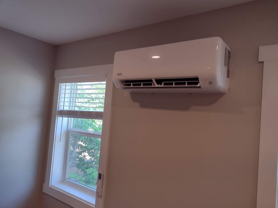 North/East living room window showing ductless AC/heating unit. Other AC/heat unit is in bedroom.