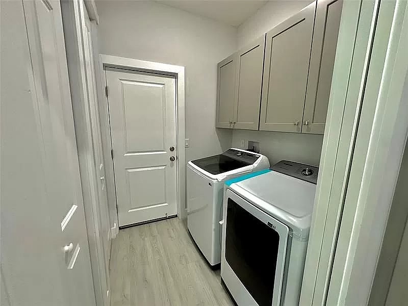Laundry room with new washer and dryer