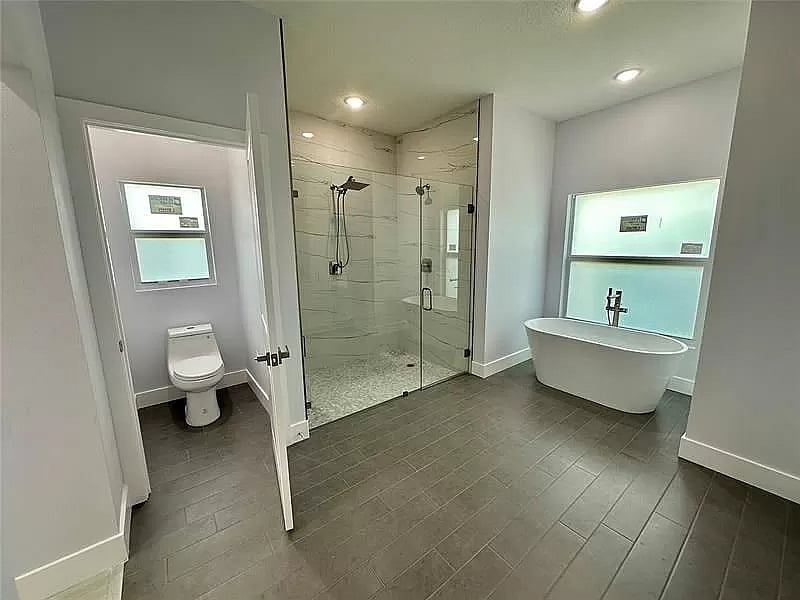 Master bathroom with his and her sinks and closets