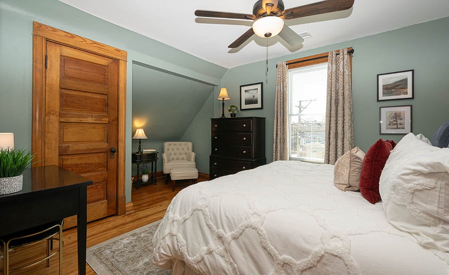 Bedroom with California King bed a vanity table and a reading nook