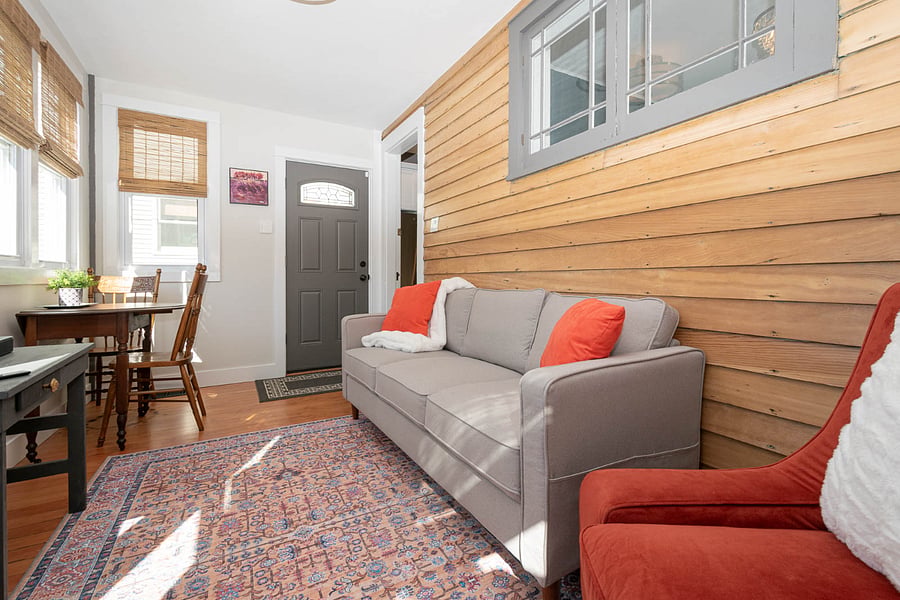 Original wood wall provides a cozy feel to this bonus family room