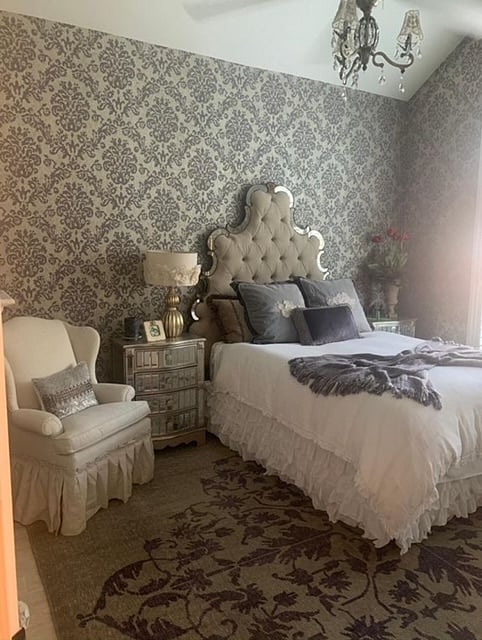 First level bedroom with fireplace, ceiling fan, and smart TV