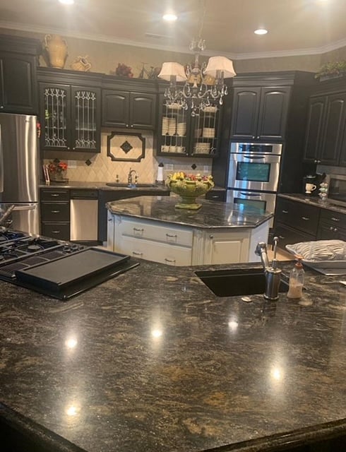 Gourmet styled kitchen with granite countertops and black stainless steel sinks.