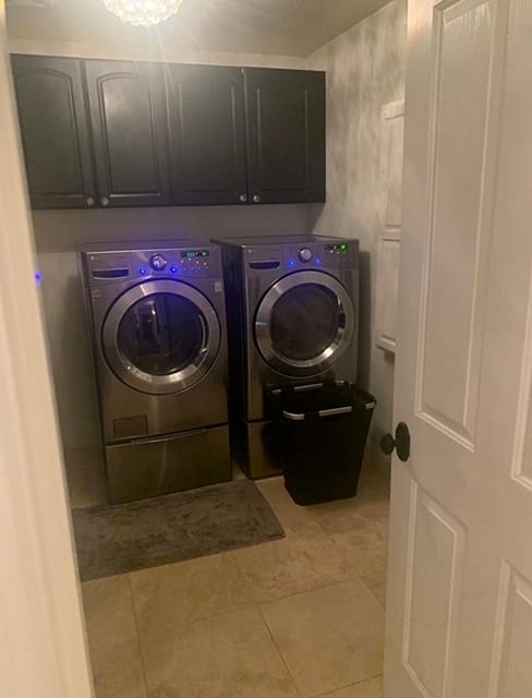 2nd level laundry room with storage cabinets 