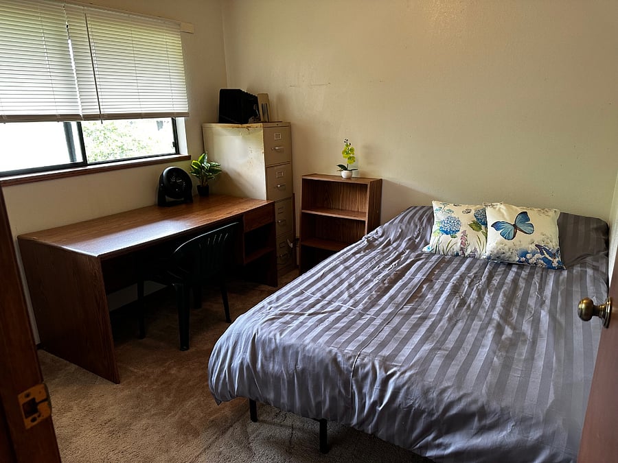 Second queen bedroom setup with workspace for remote work or study