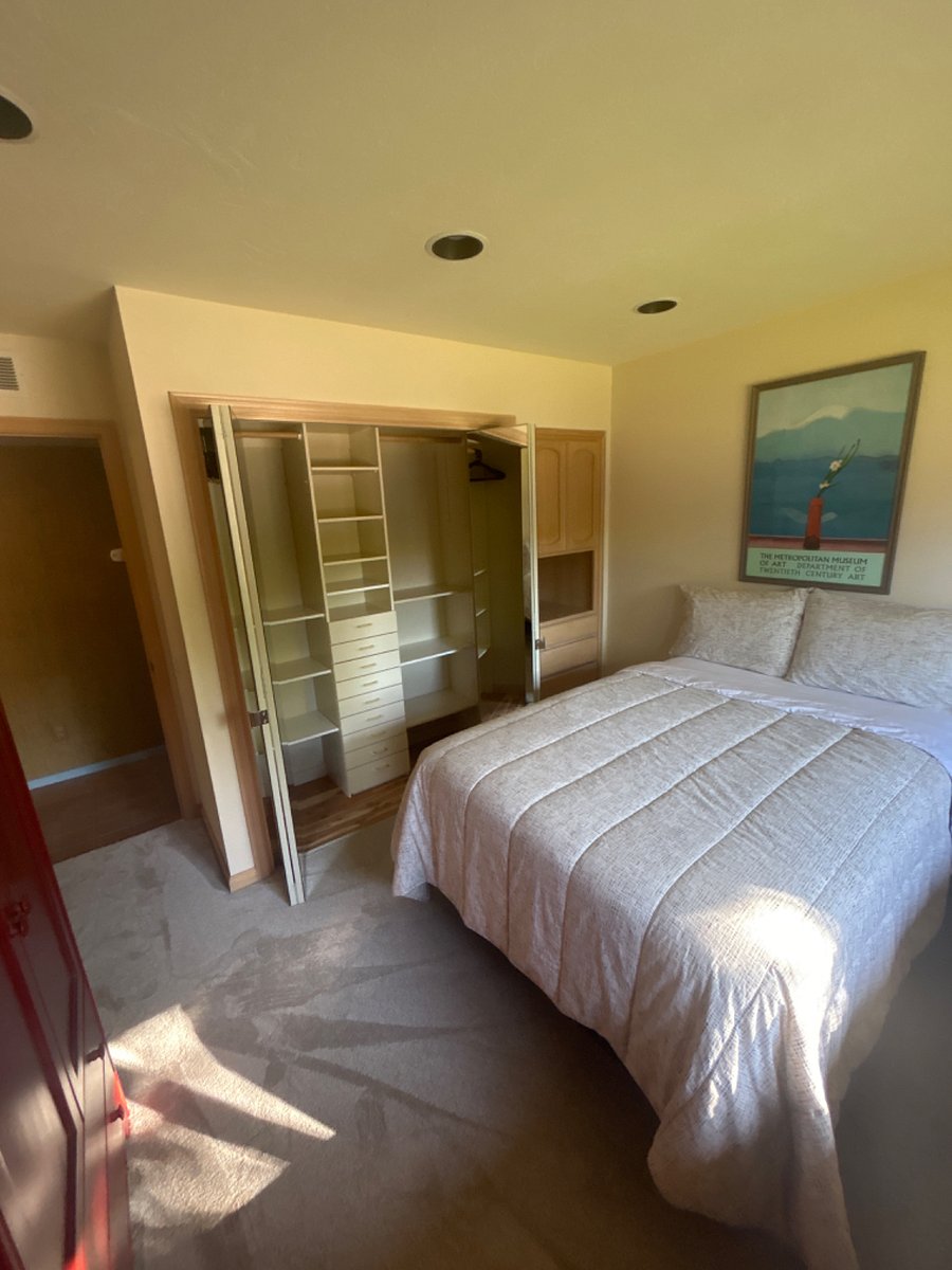 2nd bedroom/office with new carpet, built-in dresser, custom closet w/ organizer, and cedar floor