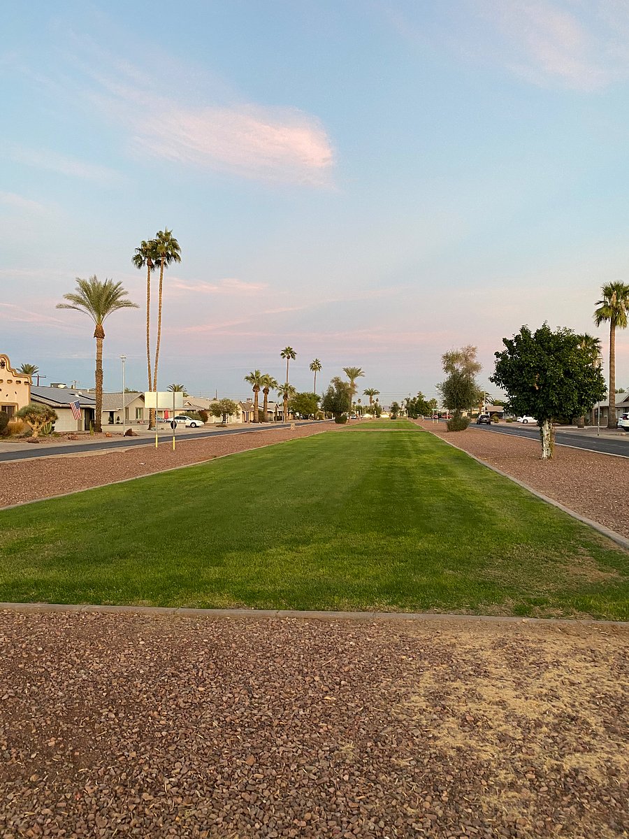Median between east and west bound Peoria in front of the house. Great for walking dogs.