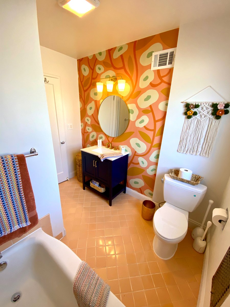 Bathroom with tub, shower and vanity. Stocked with hairdryer, towels and starter toiletries.