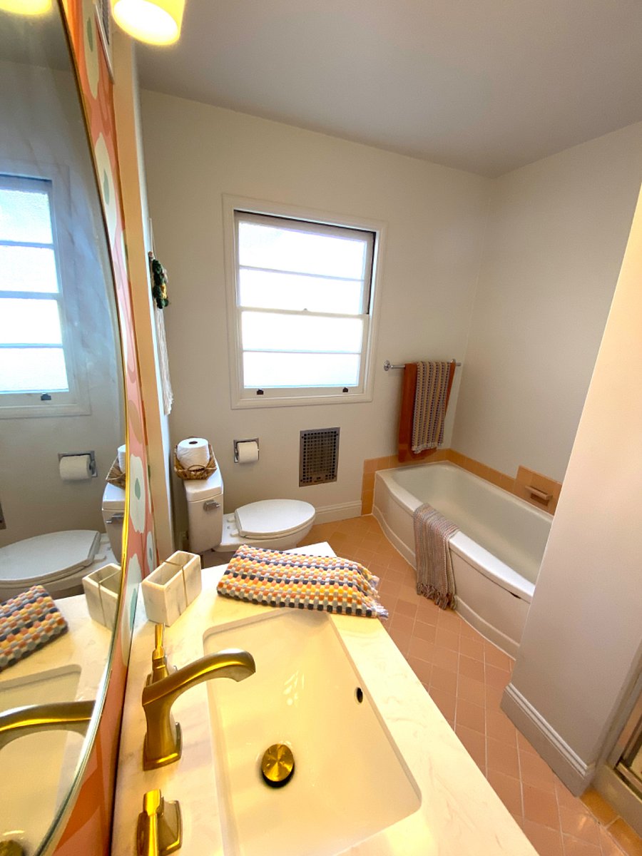 View of tub and privacy glass window.