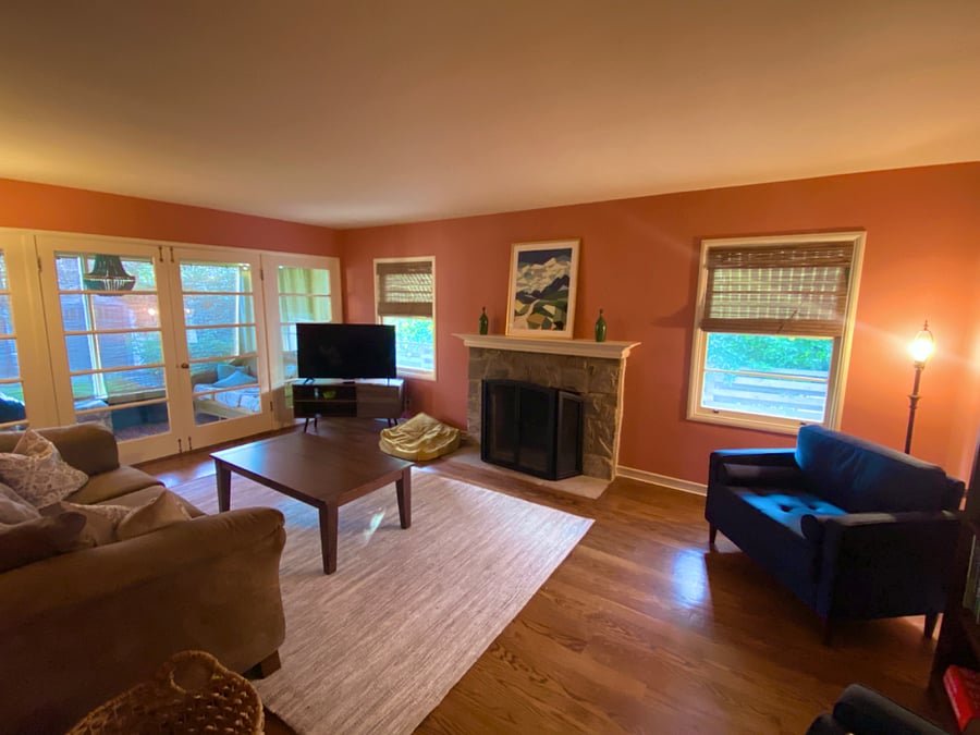 Living room view from front doorway area out to backyard via French doors to the sunporch.