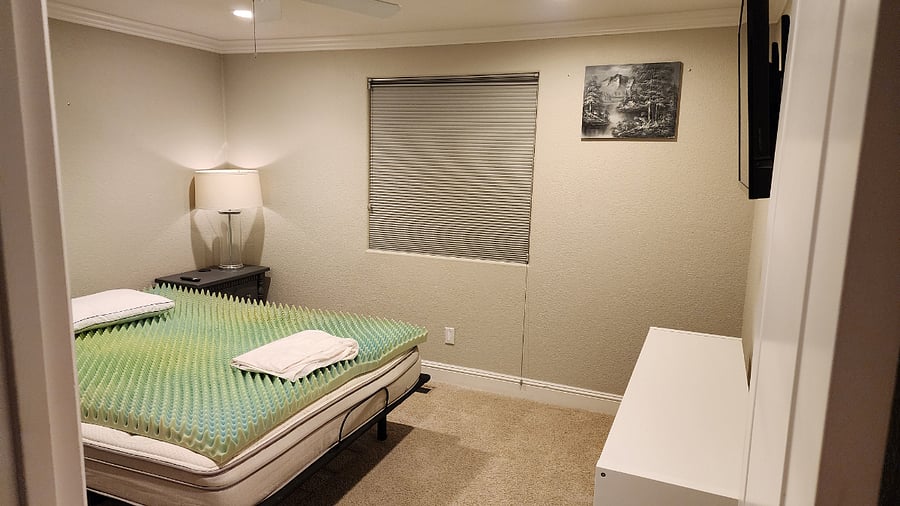 Bedroom #2 - Queen Size Sleep Number Bed, Nightstand, Chair, Smart TV, and basic closet