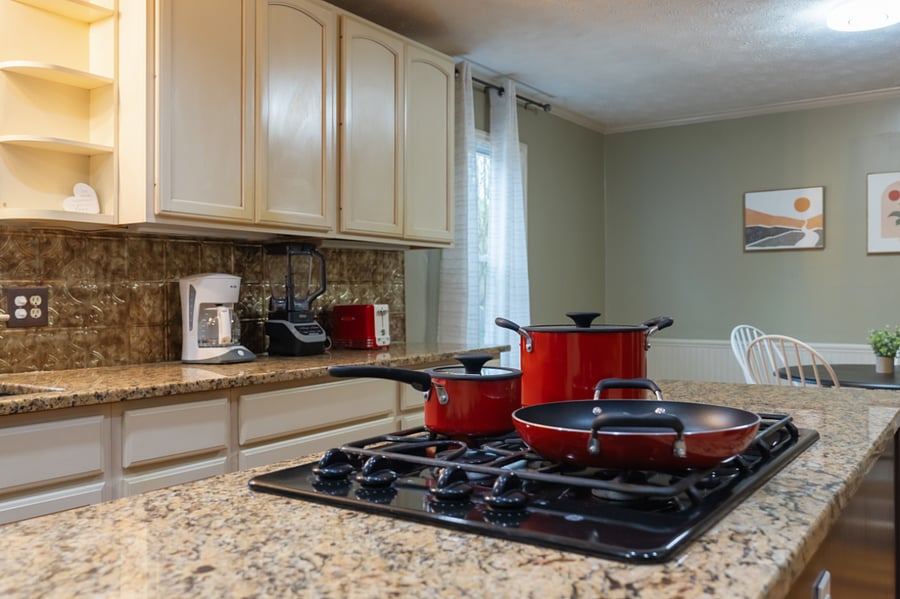 Dining with gas stove , coffee maker , blender and toaster , pots and pans