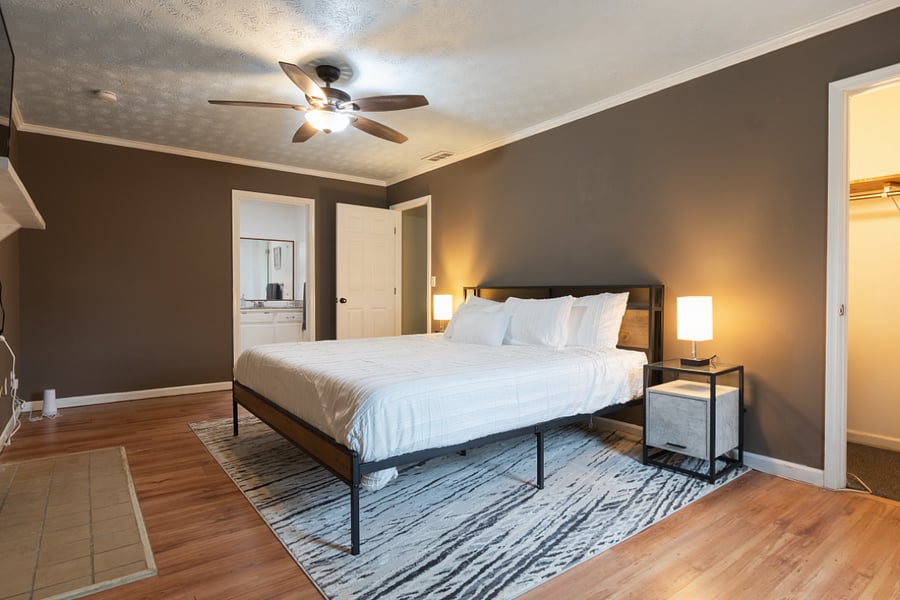 Master bedroom with smart TV and storage space