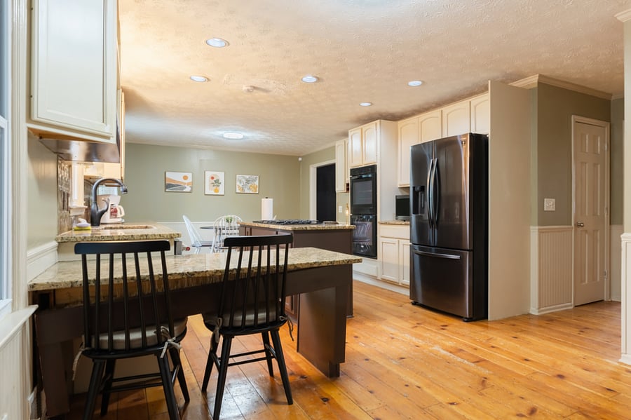 Dishwasher , double door Samsung refrigerator and 2 ovens with additional sitting and plenty of cabinet space . Kitchen view is that of the swimming pool