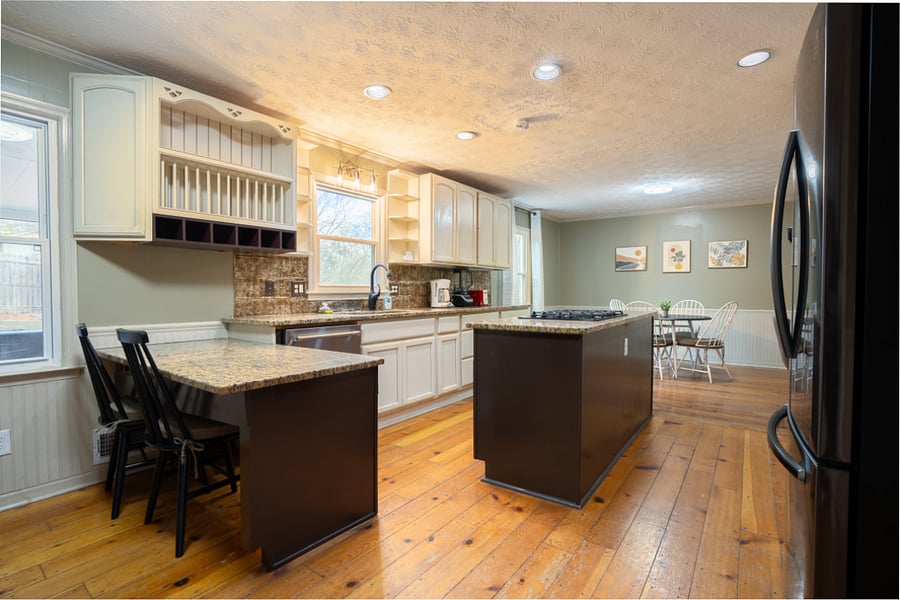 Spacious kitchen with additional sitting counter space . Well lighted and lots of cabinet space