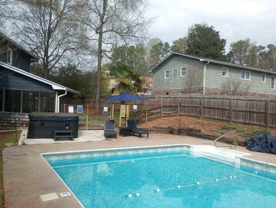 Outdoor large swimming pool with demarcated kids side upto 5 ft and the rest adult upto 12 ft deep