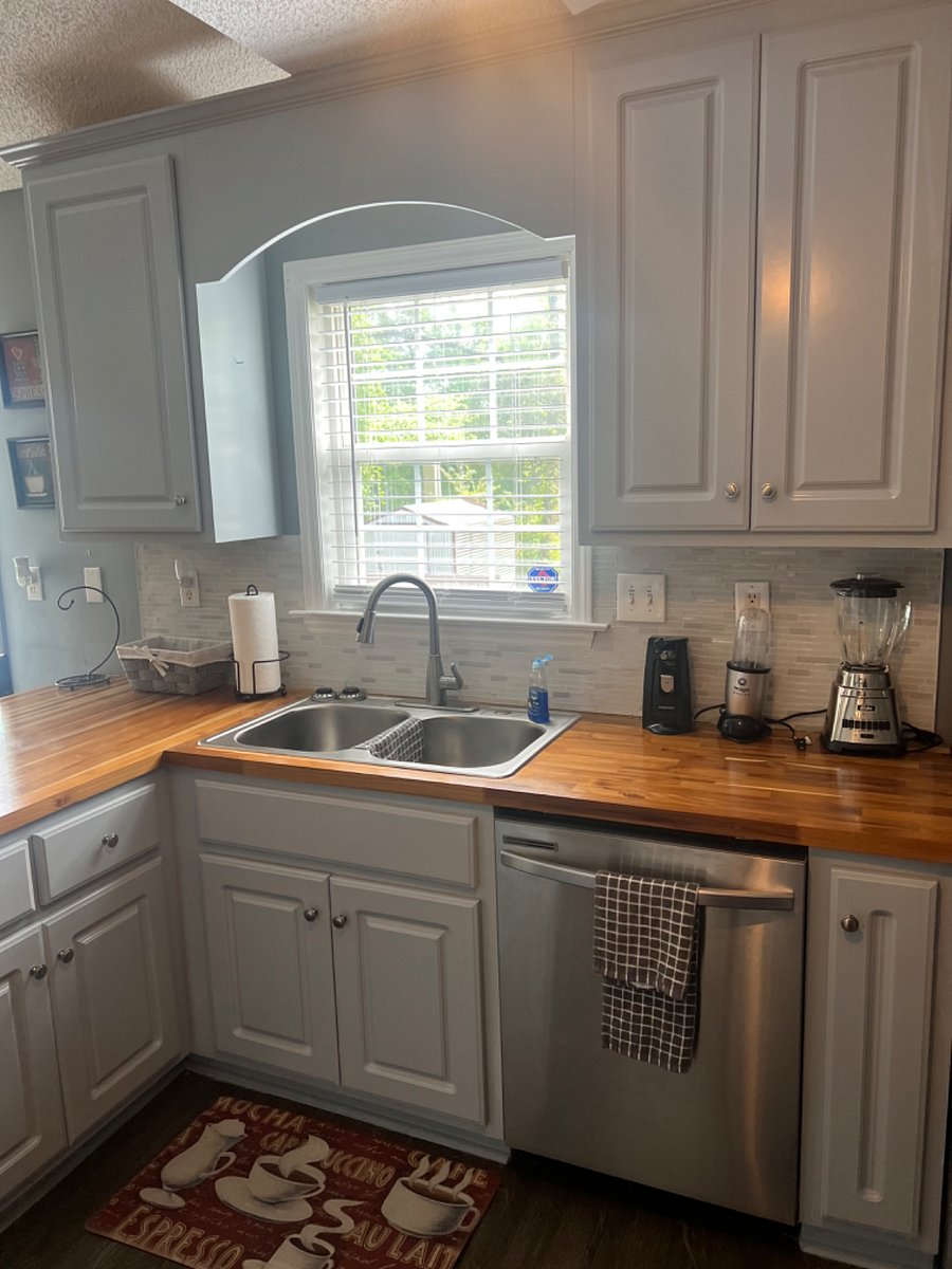Kitchen is well lit with various amenities