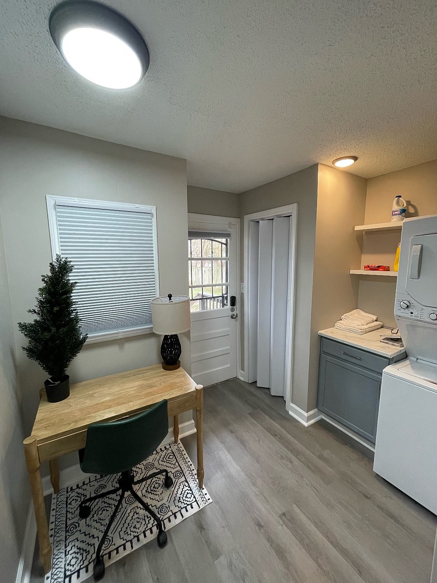 Work area with comfy chair and window. Stackable washer-dryer and work station to fold your clothes