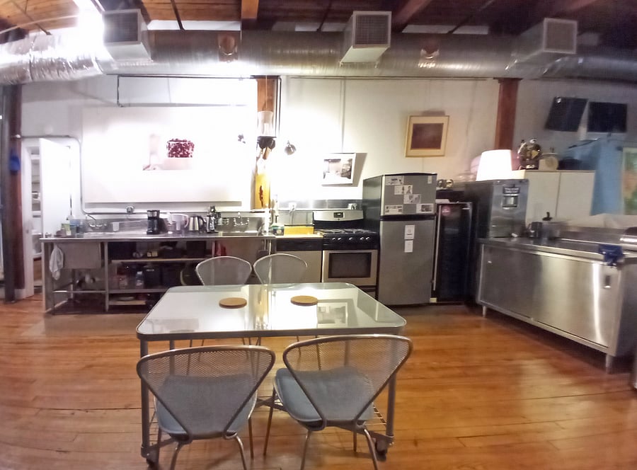 A view of the industrial kitchen, featuring professional-grade cooking surfaces for a culinary experience that blends functionality with a touch of sophistication.