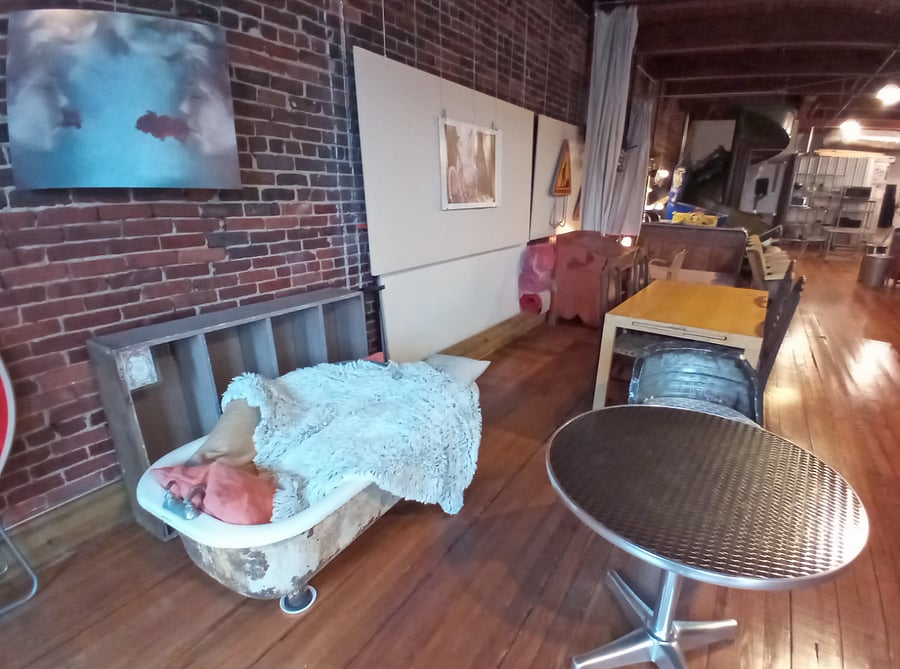 Experience the delight of an unexpectedly comfortable reading nook created from a repurposed cast iron tub.