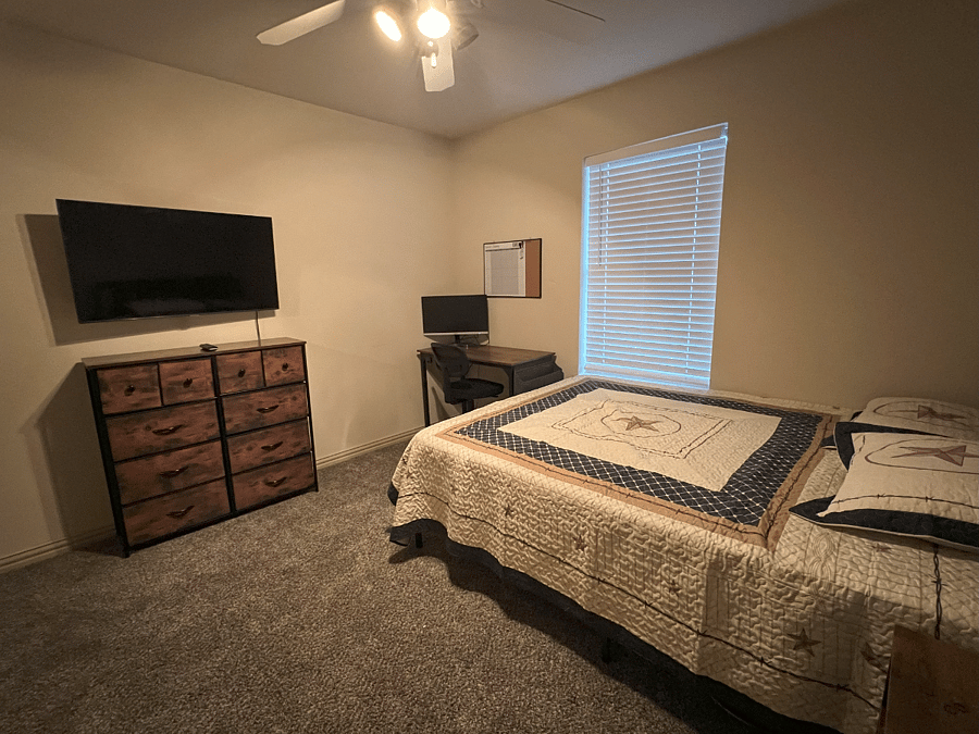 Bedroom with Mounted TV and Desk Work area