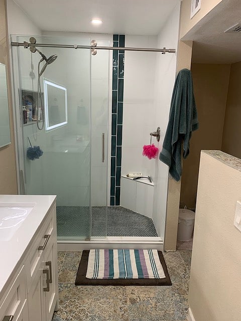 Large walk in shower with sliding glass doors