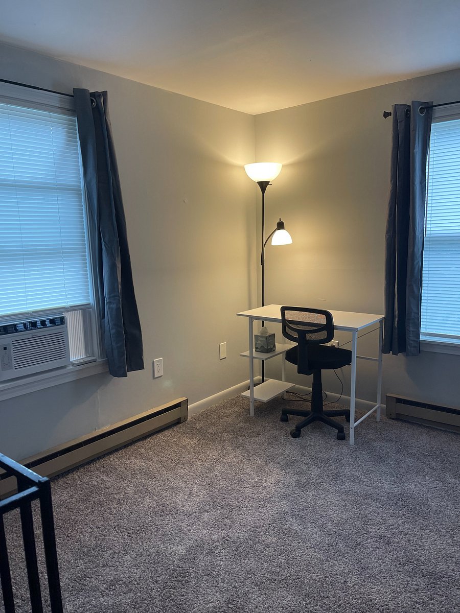 2nd floor bedroom work area with window a/c unit. Bathroom is on first floor. Spiral staircase