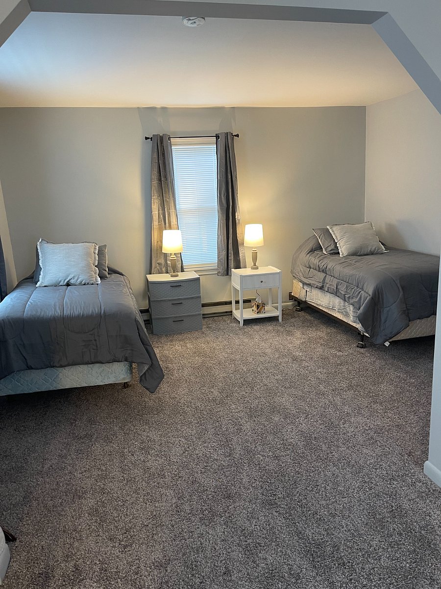 2nd floor bedroom with two twin beds. Bathroom is on first floor. Spiral staircase