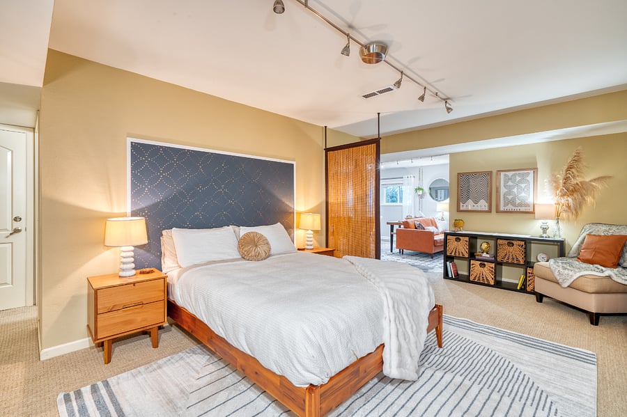 Bedroom into living space. Just behind screen is a kitchen bar with two stools if guests would like to visit while there's a cook in the kitchen.