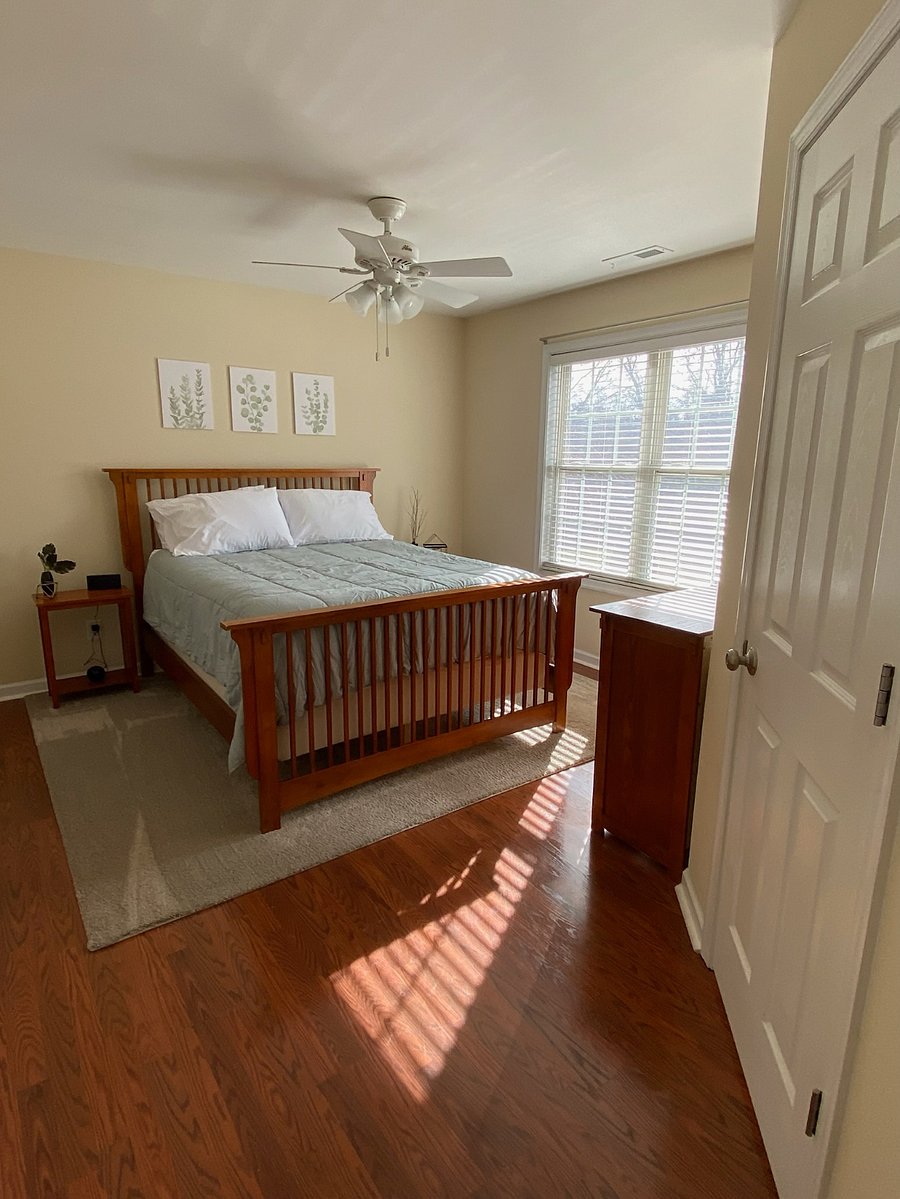 Master bedroom with dresser, private bathroom and walk-in closet