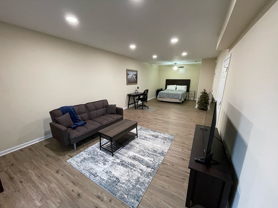 Basement bedroom/living room with desk 