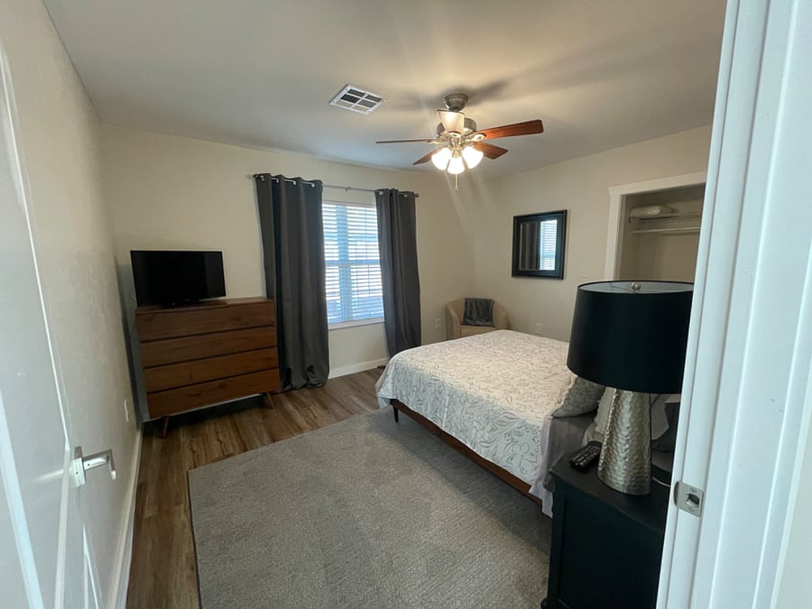 Main bedroom has blinds and blackout curtains. 
