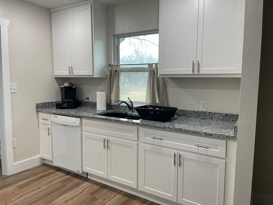 Kitchen with a dishwasher, garbage disposal, and new cabinets and granite countertops. 