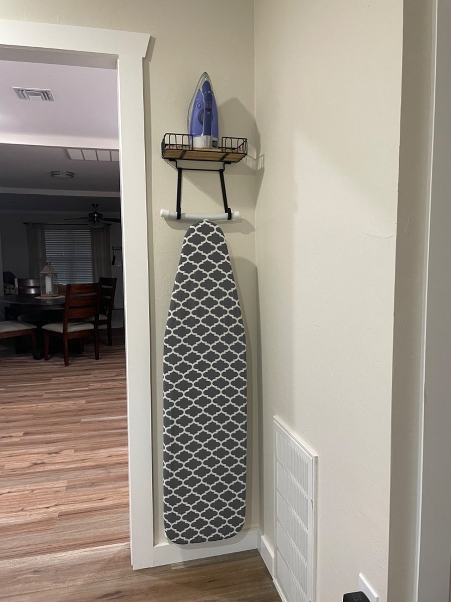 Iron and ironing board in the utility. 