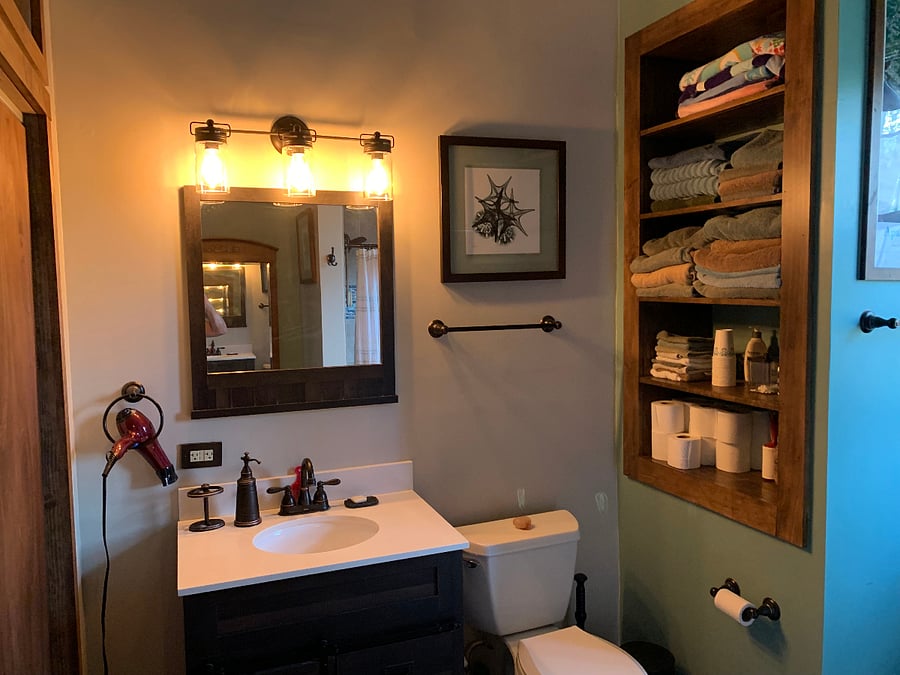 Bathroom equipped with towels, supplies and some closet space