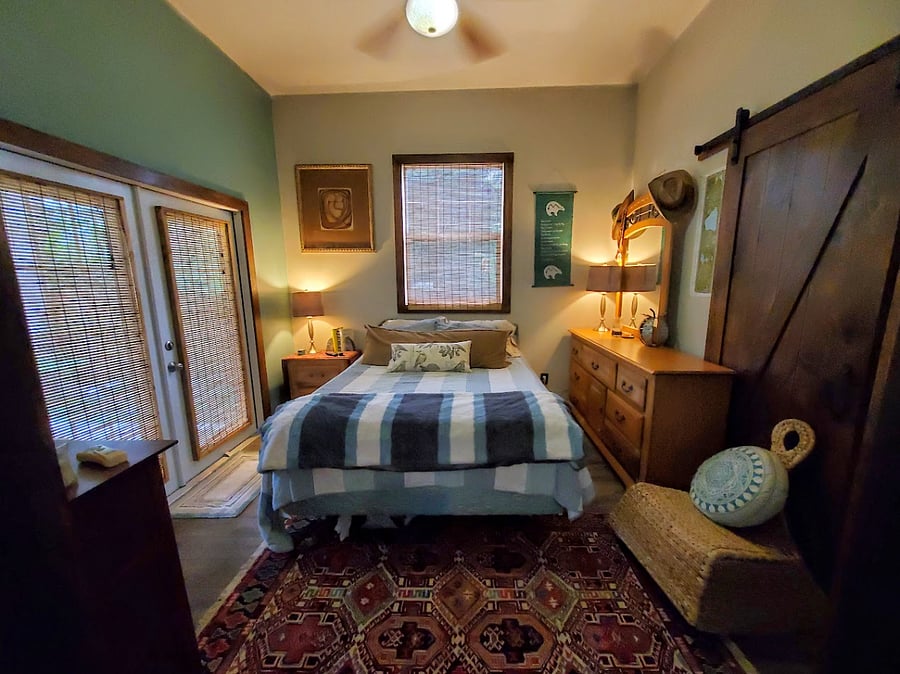 Bedroom and door to deck, house has 2 dressers, night stand and bookshelves that can be used by guest