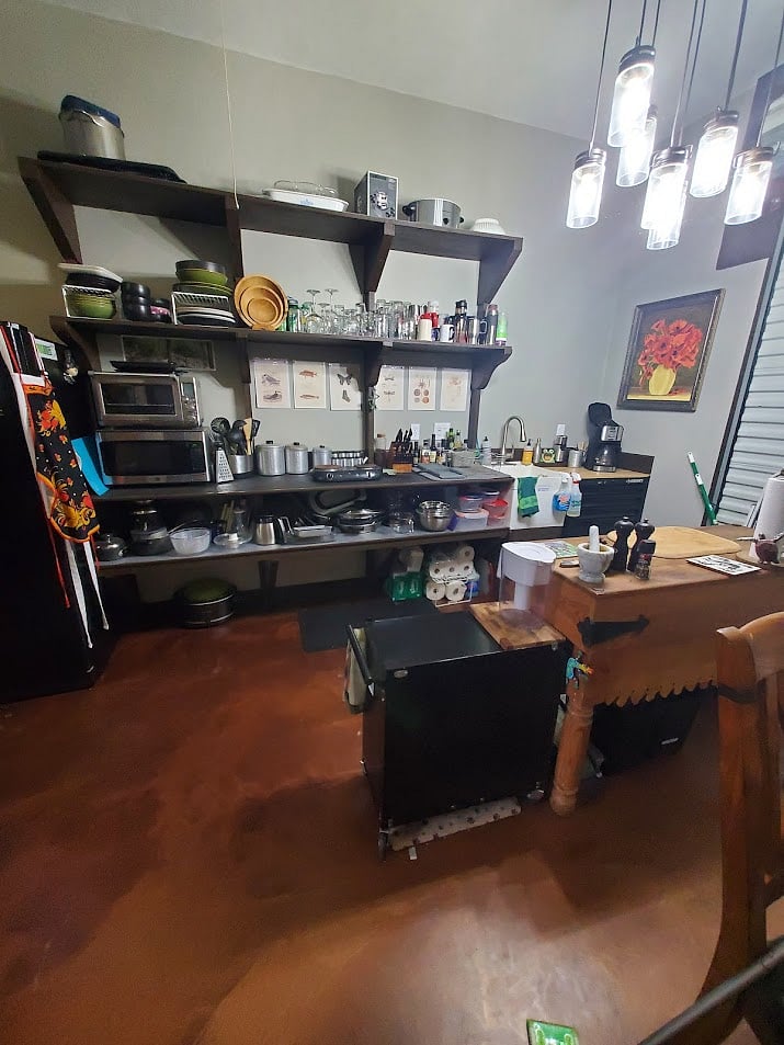 Kitchen area, sink, hot plate, crock pot, microwave, toaster oven, dishes, and plenty of cookware