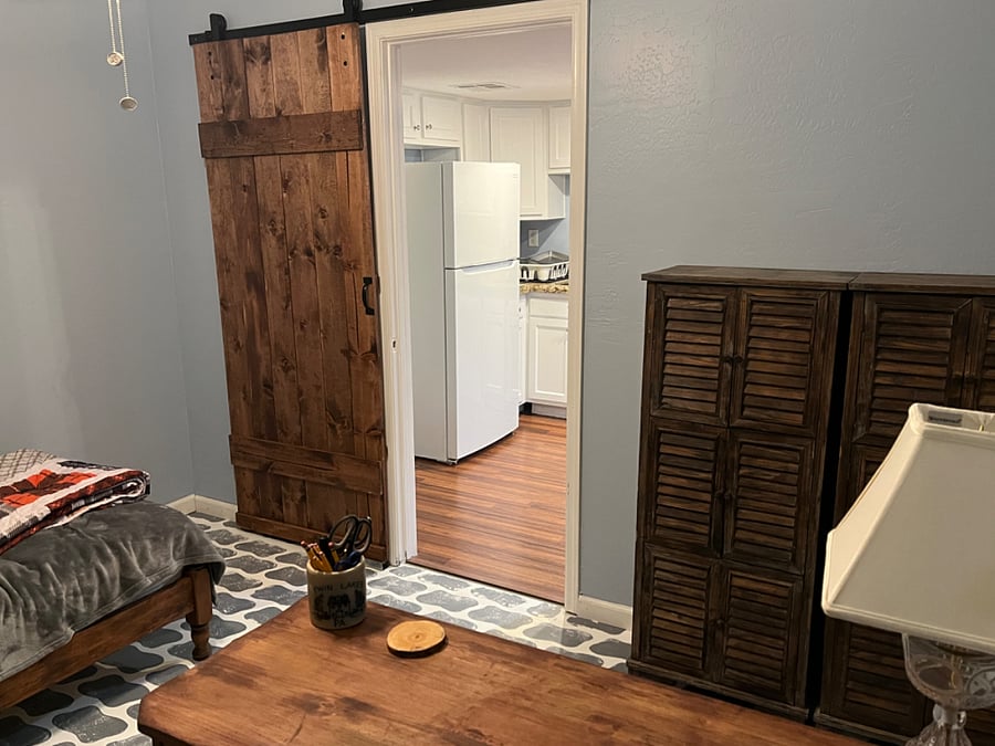 2nd bedroom, barn door, dressers, twin bed and desk
