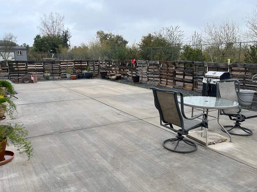 large patio area shared between both duplex units with patio furniture with more in the plans