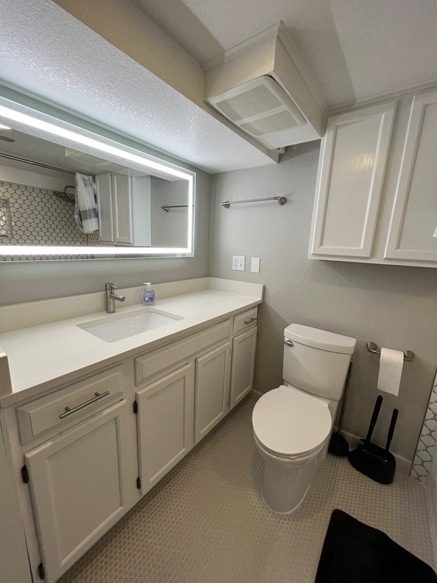 Spacious bathroom with plenty of counter space and storage under sink. Includes 2 sets of towels, bathmat, shower curtain, and starter hand soap, toilet paper, and cleaning supplies.