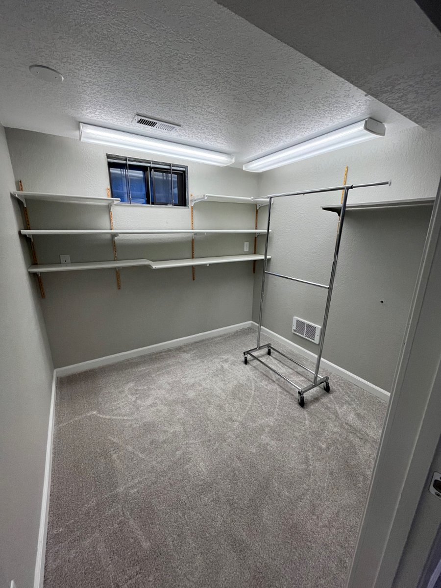 Bonus room to use as an office, workout space, walk-in closet, or for storage.
Rolling clothes rack in bonus room can be moved to bedroom if using as an office or storage space.
Shelves can be removed for more space.