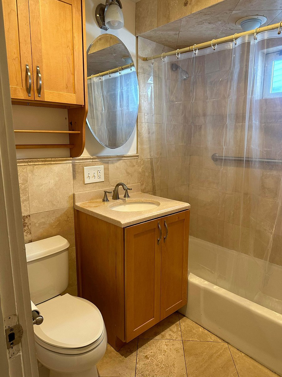 Bathroom (currently has a white shower curtain.)