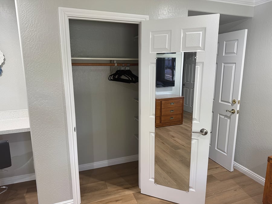 Clothes closet with pole and lots of shelving