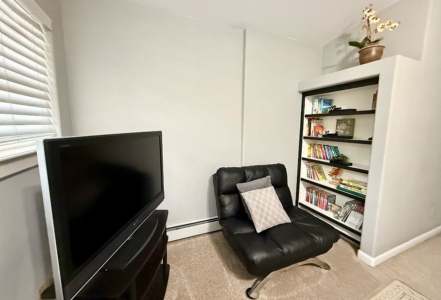 smart TV and reading corner in master bedroom